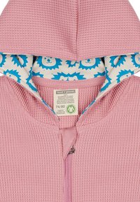 Felpa con zip in cotone rosa chiaro, con una texture a nido d'ape, caratterizzata da una fodera con motivo leone blu e un piccolo etichetta del marchio all'interno.