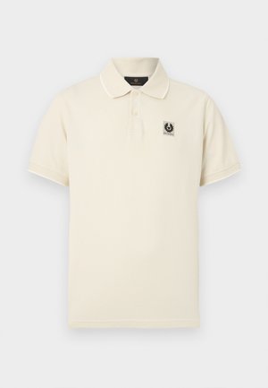 Προσαρμοσμένο polo μπλουζάκι σε κρεμ απόχρωση από βαμβάκι, με τρία κουμπιά και μικρό λογότυπο στο αριστερό στήθος. Μανίκια κοντά.
