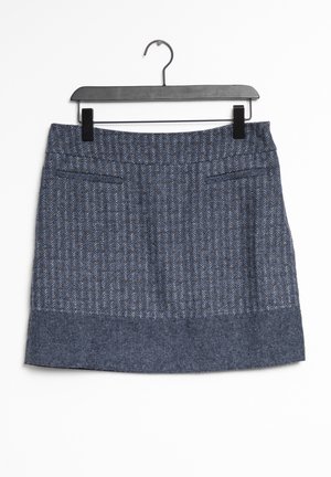Blauwe twijde rok met een gestructureerd visgraatpatroon, recht model en twee voorzakken. Het hangt aan een zwarte hanger tegen een witte achtergrond.