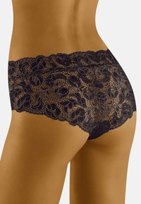 Culotte en dentelle noire avec motif floral, dotée d'une taille en dentelle festonnée et d'une texture délicate, conçue pour un silhouette ajustée.