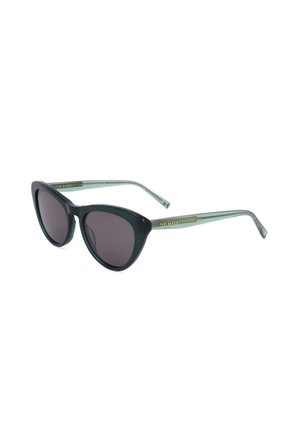 Occhiali da sole in stile cat-eye con lenti scure e aste verdi traslucide, con un piccolo logo Ted Baker sulle aste.