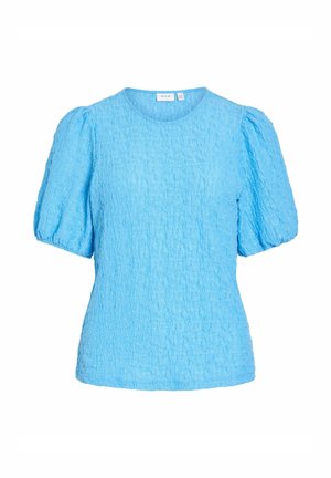 Blouse bleu clair texturée à manches courtes bouffantes avec un col rond, conçue pour un look décontracté ou semi-formel.
