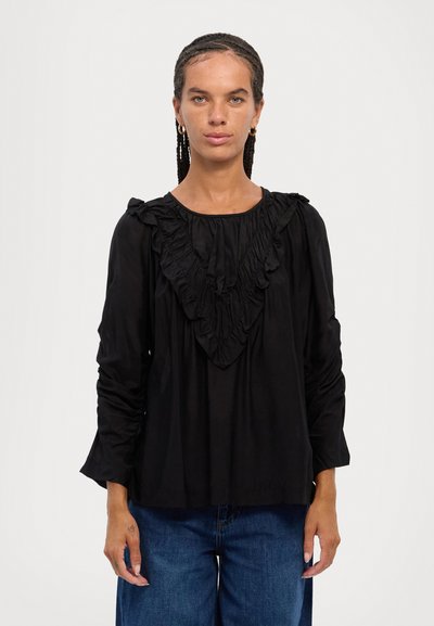 Black long-sleeve blouse featuring ruffled detail along the neckline and shoulders. The fabric appears smooth and lightweight, with a loose fit.