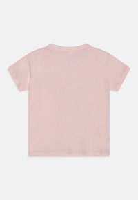 Kortärmad, ljusrosa bomullspolo med klassisk krage och en slät, mjuk textur. Har en ren, minimalistisk design på baksidan.