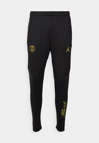 Černé sportovní kalhoty s tapered střihem, se žlutými logy a akcenty. Vyrobené z hladkého, pružného materiálu s texturovanými detaily po stranách.