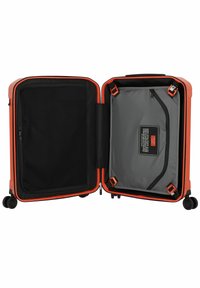 Hard-shell suitcase in bright orange with black accents. Interior features a mesh pocket and a gray compartment with a zip closure. Four wheels.