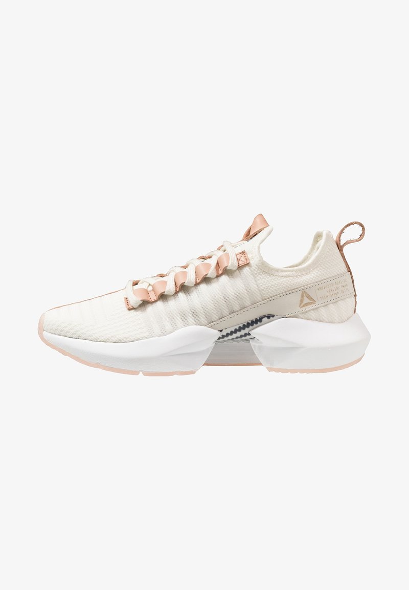 Lightweight sneaker featuring a textured cream upper, peach accents, unique lacing system, and a chunky white sole with gray details.