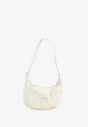 Cream-colored shoulder bag made of soft fabric with a ruched design, featuring a drawstring closure and adjustable strap.