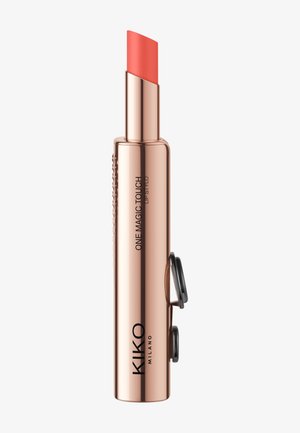 Rose gold lipstick tube with a unique twist mechanism, featuring a slightly slanted coral lip stick. Branding visible on the side.
