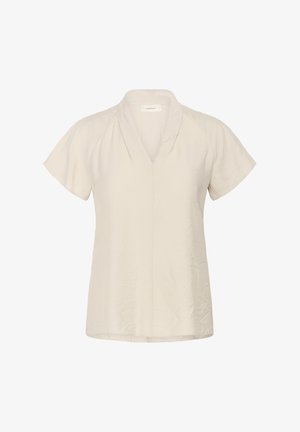 Svetlo bež bluzica s kratkimi rokavi z V-izrezom, ohlapno prileganje, subtilna tekstura in raven rob. Brez vidnih vzorcev ali dodatkov.