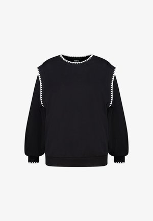 Sweat-shirt noir à manches longues avec gilet sans manches noir par-dessus, tous deux bordés d'une bordure blanche en forme de festons au niveau du col, des emmanchures et des poignets.