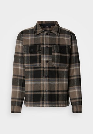 Brown and black plaid shirt made of soft fabric, featuring a button-up front, two chest pockets, and a classic collar design.
