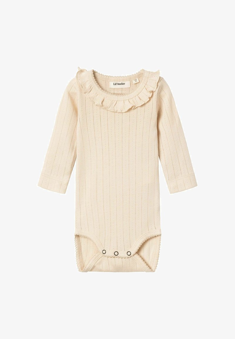 Dolgoročni kremni rebrasti bodi z nabranim ovratnikom, z gumbom na dnu in z drobnimi teksturiranimi podrobnostmi po vsej tkanini.