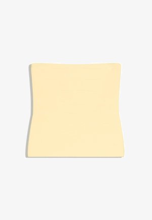 Lysebeige lændestøttepude med en kontureret form designet til at passe til lænden, vist på en hvid baggrund.