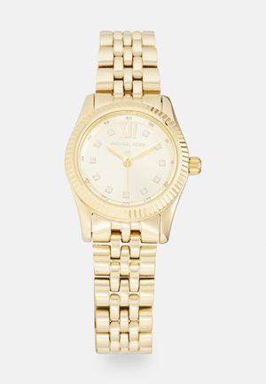 Gold-tone Michael Kors watch with a round case, textured bezel, and a link bracelet. The face features diamond hour markers and Roman numeral XII.
