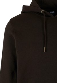 Felpa marrone realizzata in materiale morbido, con cappuccio regolabile arricchito da dettagli metallici e una vestibilità rilassata.