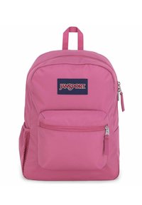 Roze stoffen rugzak met een voorvak met rits, een mesh zijvak en een handvat aan de bovenkant. Bevat een marineblauwe Jansport-logo patch aan de voorkant.