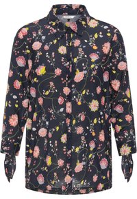 Camisa de manga larga con botones en tela azul marino que presenta un patrón floral en tonos rosa, amarillo y verde, con lazos en las mangas.