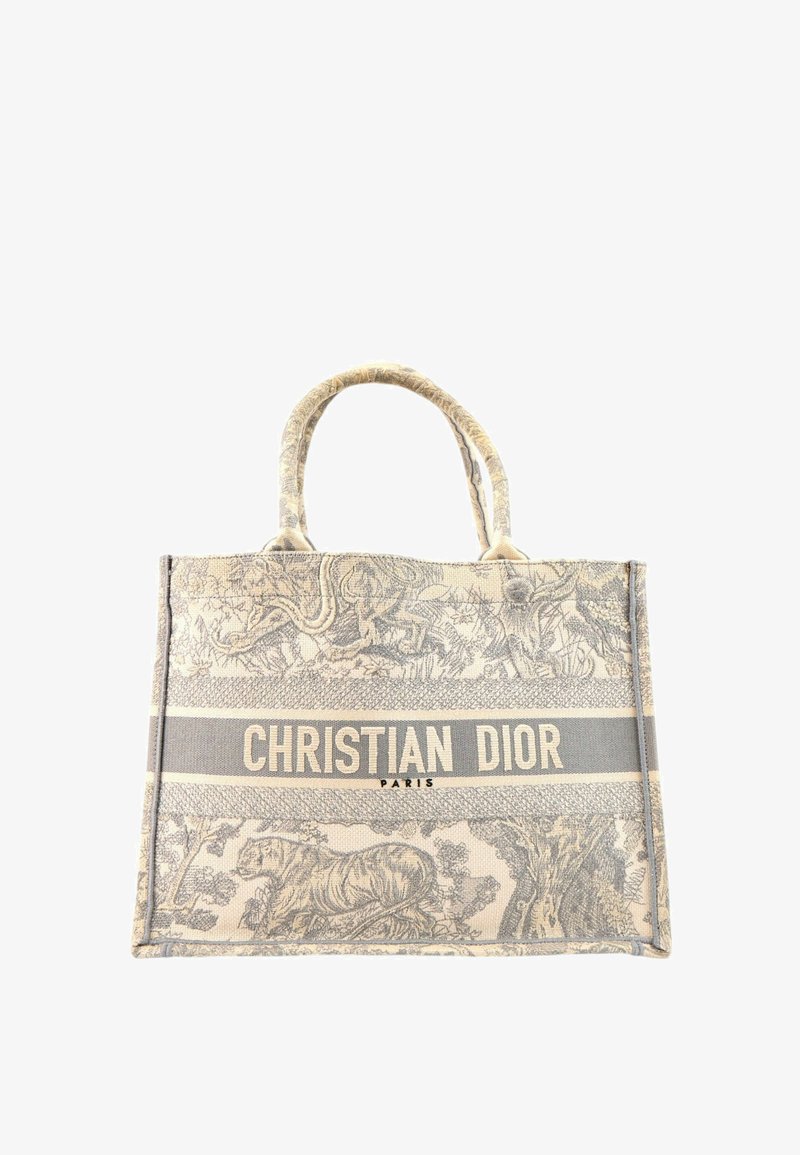 Sac cabas beige et gris Christian Dior avec imprimé animalier et nature, deux anses et texte "Christian Dior Paris" à l'avant.