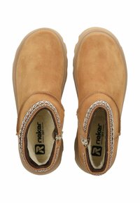 Bottines en suède beige avec un bout rond, des zips sur les côtés, et une doublure intérieure contrastante. Semelle en caoutchouc épaisse pour une meilleure adhérence.