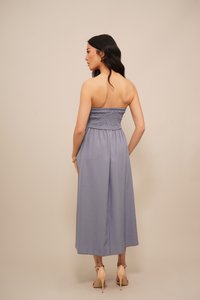 Pufasta zaključena brez naramnic, enodelna obleka v svetlo modri tkanini, dolžine do gležnjev s širokimi hlačnicami, ki se ponaša z gladko teksturo in preprostim, elegantnim dizajnom.