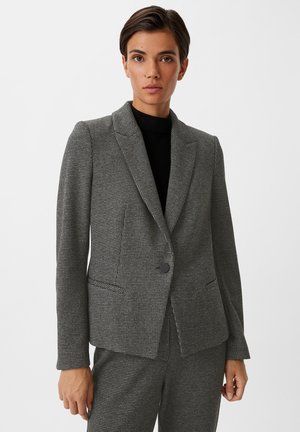 Grijze geruite blazer met notch-lapel, enkele knoopsluiting en twee voorzakken. Getailleerde pasvorm met gestructureerde stofdetails.