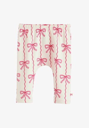 Baltos leggingai su rožinėmis kaspinų raštais ir bangų linijomis. Savybės: elastinga juostos juosta ir minkšta, tampri medžiaga komfortui.