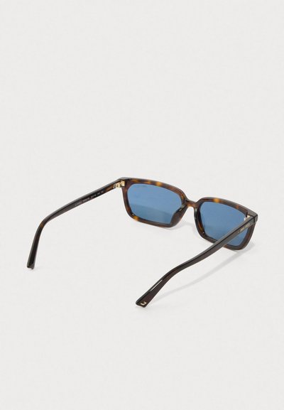 Rectangular tortoiseshell sunglasses with blue lenses and thin, slightly curved arms laid open on a white surface.