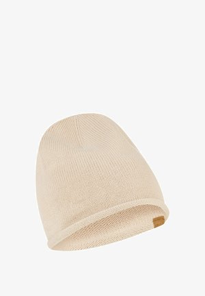 Light beige knit beanie with a rolled brim, crafted from soft material. Features a small leather tag on the side for detail.