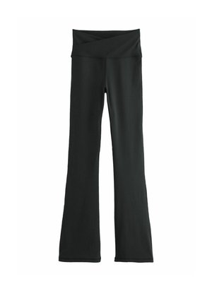 Black flared yoga pants with a wide, crossed waistband. Made from a smooth, stretchy fabric, featuring a full-length design and no pockets.