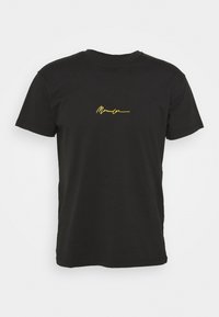 Black cotton t-shirt with short sleeves and a crew neck. Features a gold embroidered signature on the front.