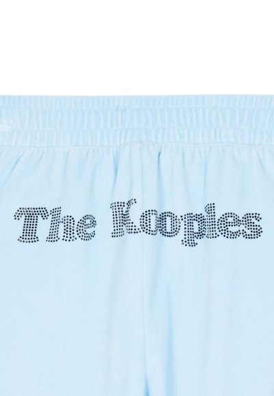 Pantaloni della tuta in cotone blu chiaro con cintura elastica, dotati di testo in rilievo nero "The Kooples" sul retro. Texture liscia.