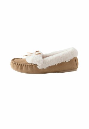 Tan suede moccasin slipper with white faux fur lining and trim, stitched detailing, and a small bow on top.