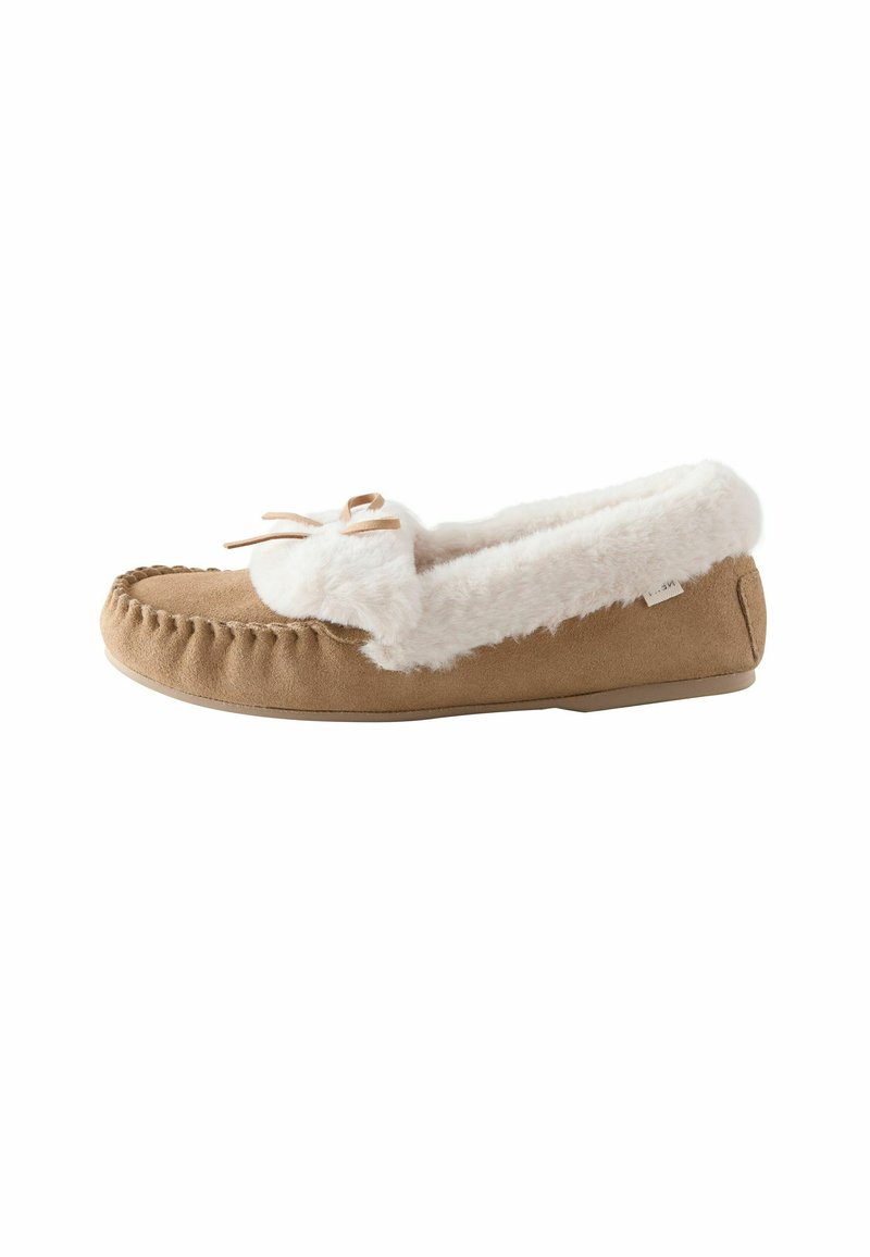 Tan suede moccasin slipper with white faux fur lining and trim, stitched detailing, and a small bow on top.