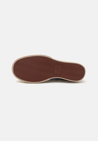 Brown rubber shoe sole with herringbone pattern and beige accents. Includes embossed brand name. Smooth edges and textured grip.