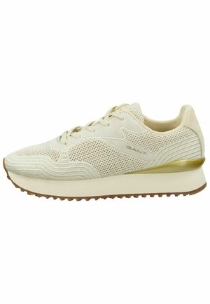 Beige Sport Schuh mit Mesh- und strukturierten Details, runder Zehenpartie, Schnürsenkeln und einer leichten Außensohle. Verfügt über einen dezenten goldenen Akzent an der Ferse.
