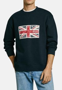 Navy sweatshirt featuring a faded Union Jack print on the front. Ribbed cuffs and hem, relaxed fit, made from cotton-rich material.