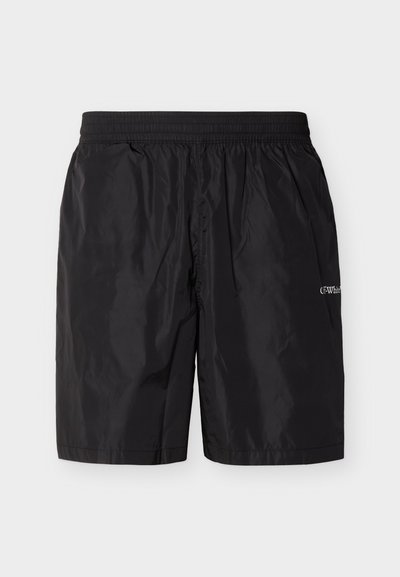Shorts de bain noirs mi-cuisses avec taille élastique et petit logo blanc "Off-White" sur la cuisse droite, présentés sur un fond neutre.