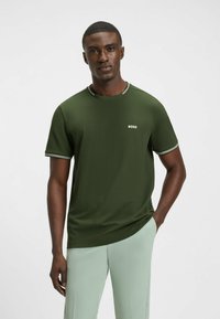 Olive green short-sleeve t-shirt with a crew neck, featuring white striped accents on the collar and sleeves and a small white "BOSS" logo.