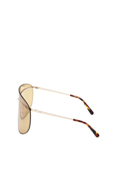 Pilotní sluneční brýle s velkými, světle hnědými čočkami, tenkým kovovým rámečkem a spánkovými patkami s želvovinovým vzorem.