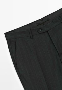 Dark gray trousers with a vertical pinstripe pattern. Features a button closure, side pockets, and a smooth texture. Tailored design.