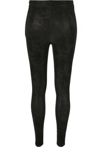 Legging noir taille haute en cuir synthétique avec finition texturée, coupe slim et coutures verticales cousues à l'avant.