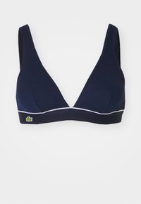 Navy-Dreieck-Bralette aus geripptem Stoff, mit weißem Besatz und kontrastierendem Band mit eingeprägtem "LACOSTE"-Logo und grünem Krokodil-Akzent.