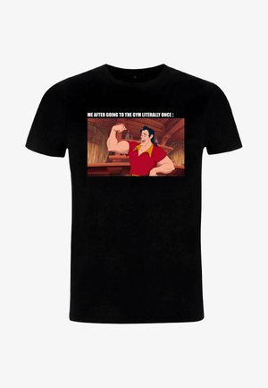 T-shirt en coton noir avec l'image d'un personnage de dessin animé et du texte au-dessus. Le personnage a les cheveux foncés, des bras musclés et porte une chemise rouge avec un col jaune.