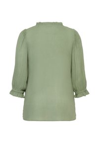 Hellgrüne Bluse mit Rüschen am Ausschnitt und dreiviertel langen Ärmeln mit elastischen Bündchen, gefertigt aus weichem, strukturiertem Stoff.