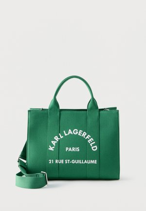 Green rectangular tote bag with two handles and adjustable shoulder strap, featuring white text "KARL LAGERFELD PARIS 21 RUE ST-GUILLAUME".