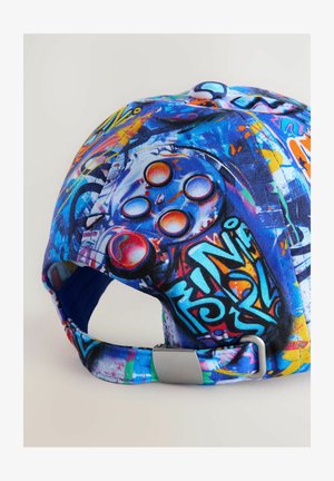 Baseball cap featuring a vibrant, multicolored graffiti design with a textured fabric. Includes a silver metal buckle on an adjustable strap.