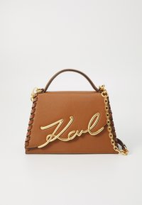 Brown leather shoulder bag with a gold scripted logo, chain detail, and a braided strap, featuring a structured triangular design.