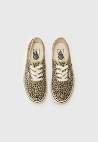 Leopard-print canvas sneakers with white laces, a rounded toe, and a rubber sole. Features a logo on the insole.
