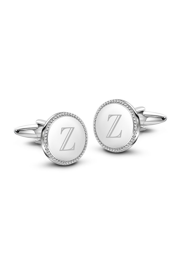 Srebrne i białe spinki do mankietów w okrągłym kształcie, z wygrawerowaną literą "Z" w eleganckiej czcionce, otoczone akcentami przypominającymi diamenty. Gładka tekstura.